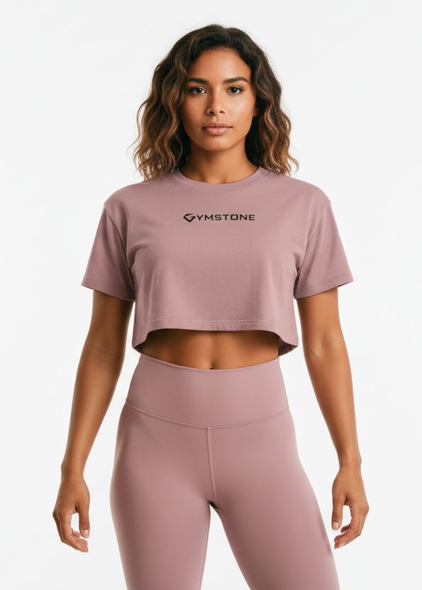 Woman wearing a mauve crop top and leggings with a brand logo on a white background