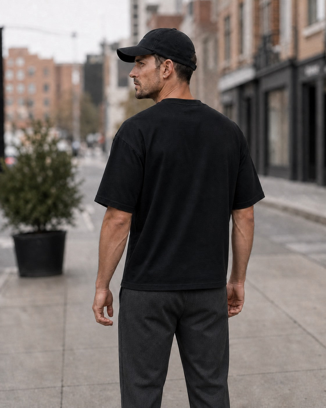 Black - Back view of the Mens Forge Box Tee on a male model outdoors.