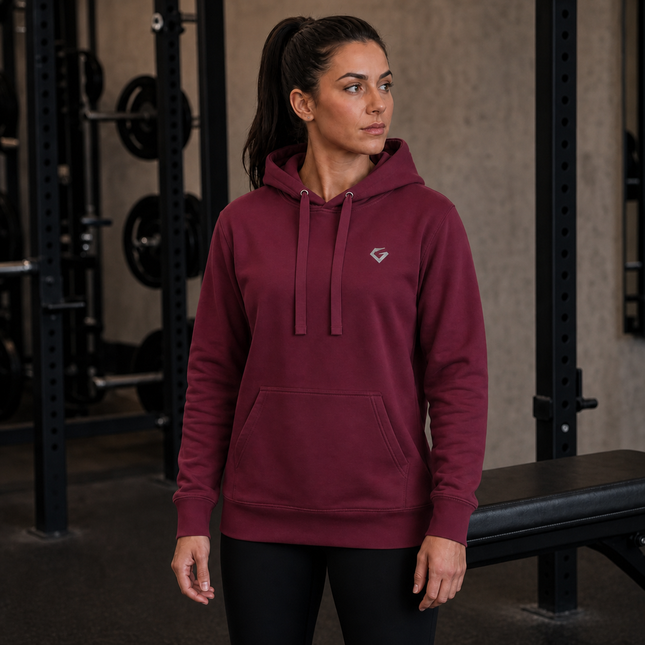 Maroon - Women's Forge Hoodie on a centered female model with full hands and upper thighs visible