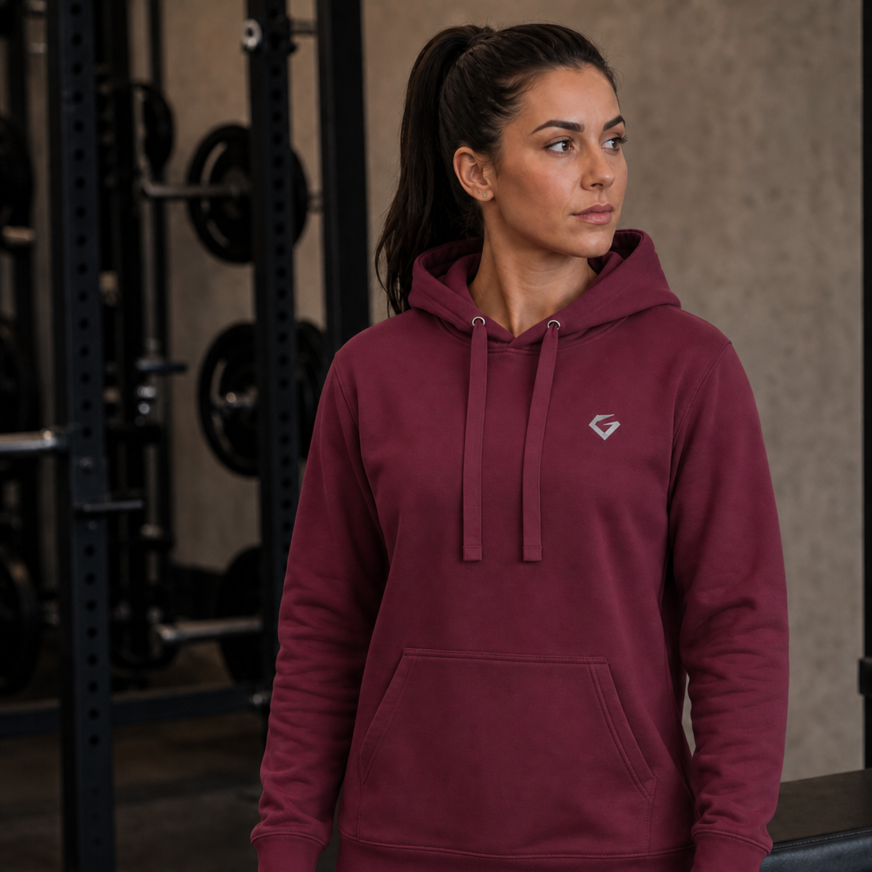 Maroon Women's Forge Hoodie on a female model in a standing three-quarter pose, with flat drawstrings